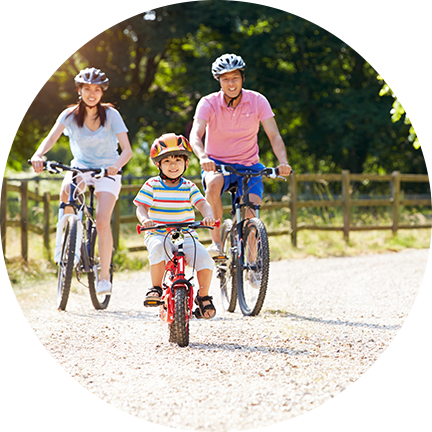 Family wearing helmets while cycling at Fairbridge Village