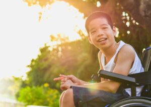 Youth on a wheelchair looking at the camera