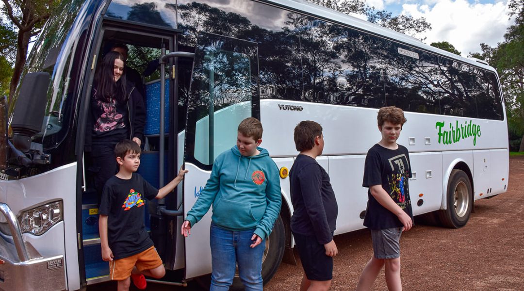 Young people associated with Fairbridge exiting a bus